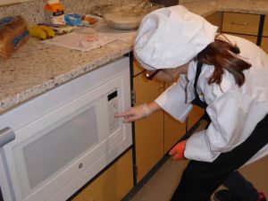 Child setting a timer on the microwave