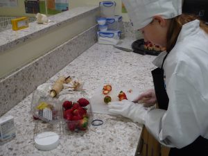 Child cutting strawberries