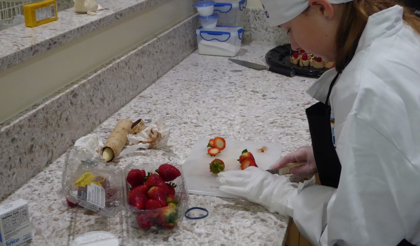 Child cutting strawberries