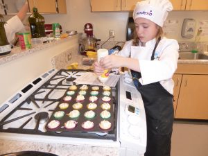 Child frosting cupcakes