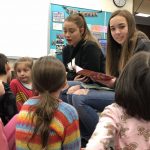 SAHS leadership students reading their children's stories to Oak Elementary students.