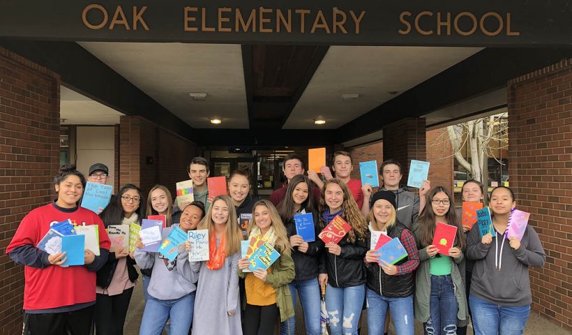 Group of SAHS leadership students showing their children's books.